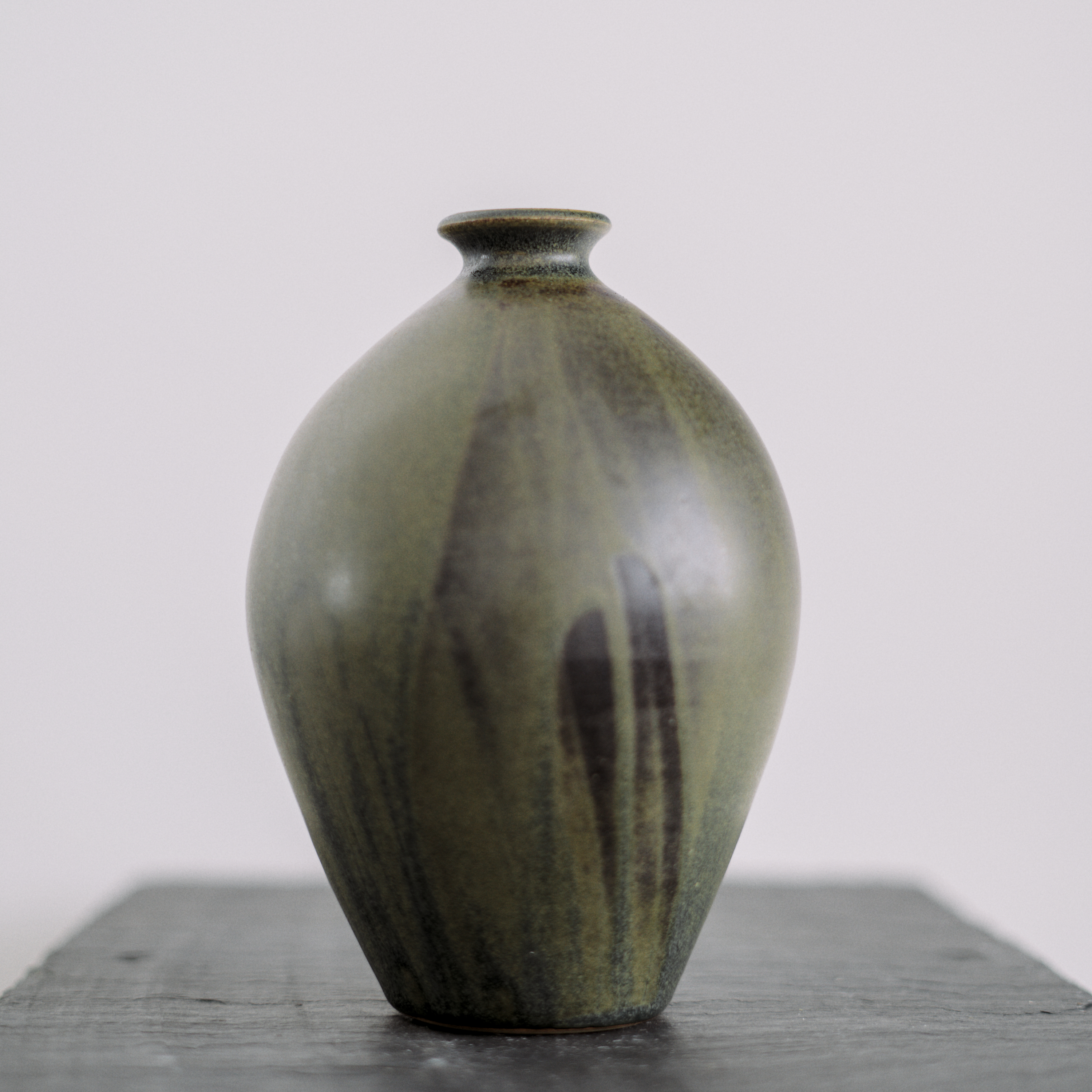 A ceramic vase with blue-green glaze